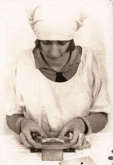 A woman seals the wrapper of a tube of Rowntree clear gums, Rowntree factory, York, 1929