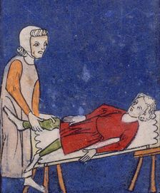 A woman setting a bone in a boy's leg, 14th century. Creator: Unknown