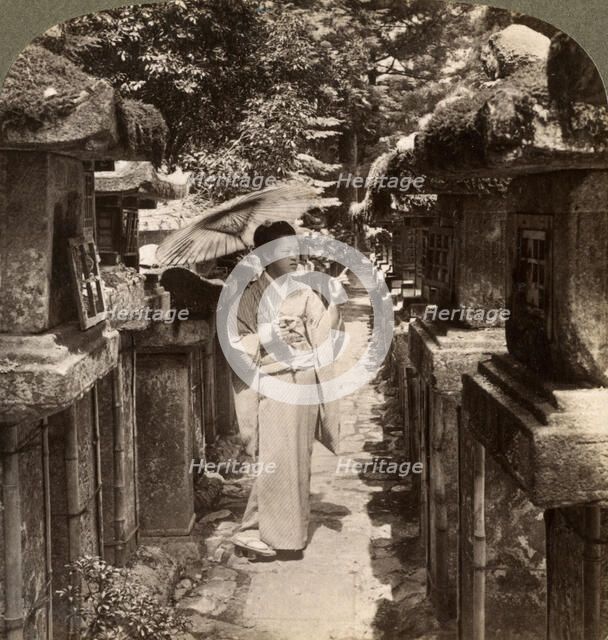 A woman Shinto devotee counting the stone lanterns, Kasuga Shrine, Nara, Japan, 1904.Artist: Underwood & Underwood