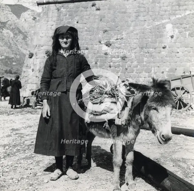 A women and her donkey, Montenegro, Yugoslavia, 1939.  Creator: Unknown.
