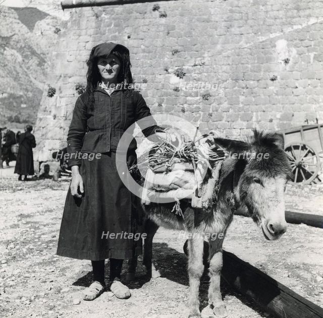 A women and her donkey, Montenegro, Yugoslavia, 1939.  Creator: Unknown.