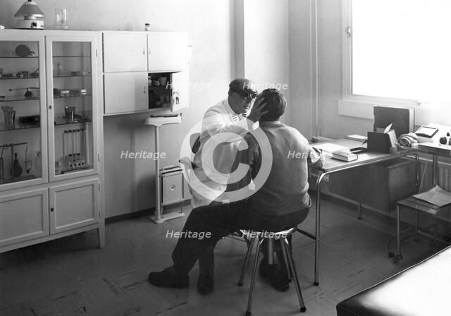 A worker at Trelleborgs rubber factory consulting the works doctor, Trelleborg, Sweden. Artist: Unknown