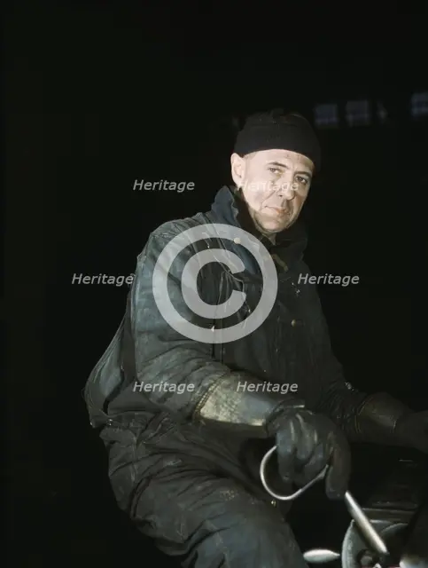 A worker in the roundhouse at the C & NW RR., Proviso yard, Chicago, Ill., 1942. Creator: Jack Delano.