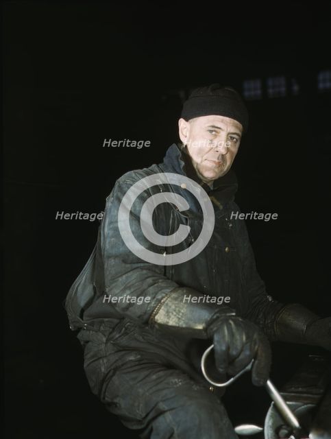 A worker in the roundhouse at the C & NW RR., Proviso yard, Chicago, Ill., 1942. Creator: Jack Delano.