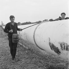 A worker walking along a section of the Fens gas pipeline, Norfolk, 24/07/1967. Creator: John Laing plc