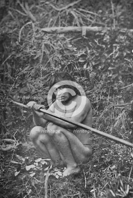 'A Yaghan Attaching The Head of His Harpoon to the Shaft', 1911. Artist: Unknown.