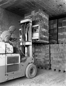 A yardsman stacking pallets of bricks, Whitwick Brickworks, Coalville, Leicestershire, 1963. Creator: Michael Walters