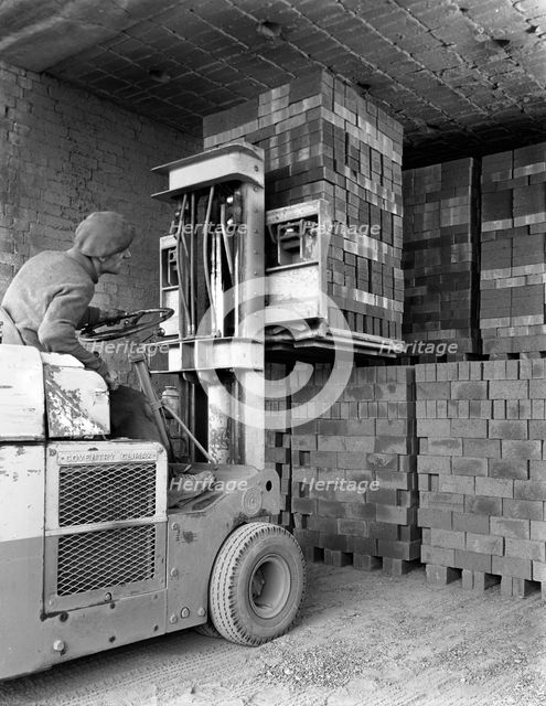 A yardsman stacking pallets of bricks, Whitwick Brickworks, Coalville, Leicestershire, 1963. Artist: Michael Walters