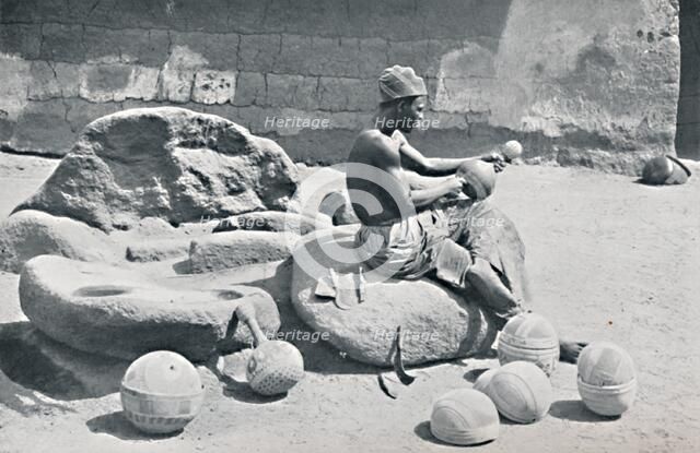 A Yoruba man engraving clay bowls and water jars, Lagos hinterland, Southern Nigeria, 1912. Artist: AW Gelston.