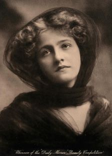 A young woman, winner of a beauty contest, wearing a large black hat with a trailing scarf..., c1904 Creator: Unknown