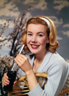 A young woman drinking a bottle of Coca-Cola, c1955. Creator: Arthur Charles Kirby Ware