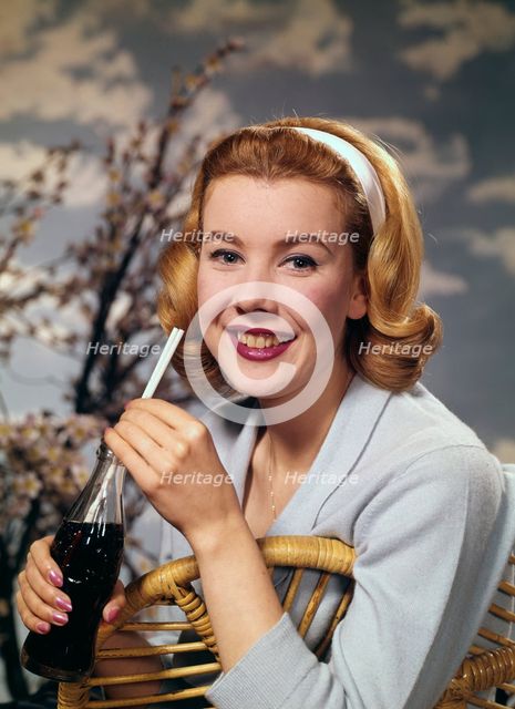 A young woman drinking a bottle of Coca-Cola, c1955.  Creator: Arthur Charles Kirby Ware.