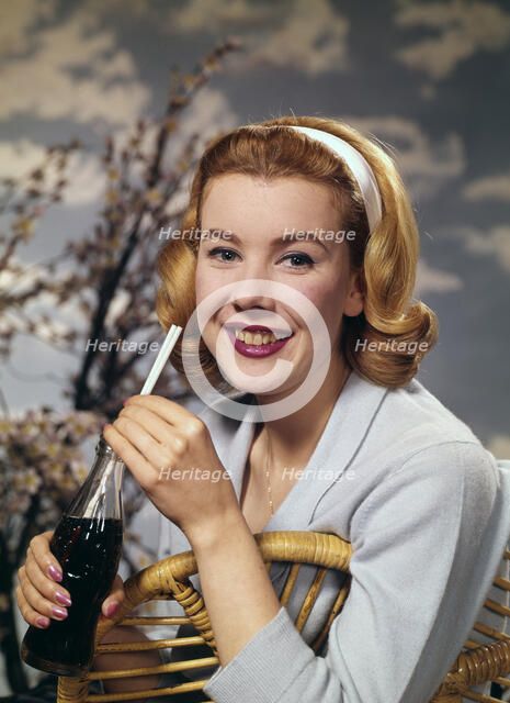 A young woman drinking a bottle of Coca-Cola, c1955.  Creator: Arthur Charles Kirby Ware.