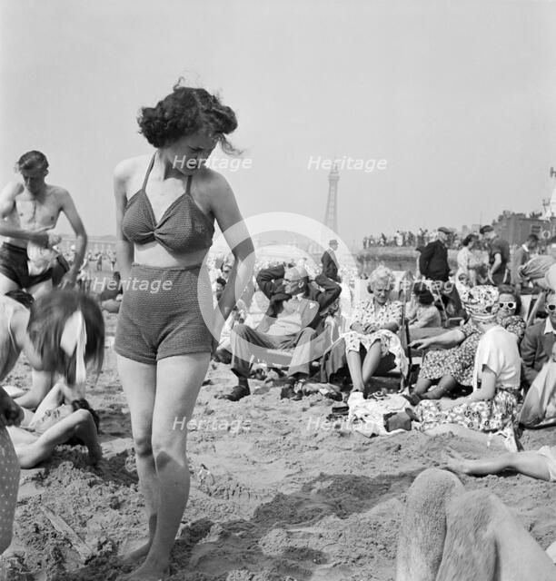 A young woman in a knitted bathing costume on the beach, Blackpool, c1946-1955. Artist: John Gay