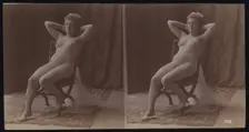 A young woman posing naked but for a long veil, leaning back in a chair, in a photographic..., c1900 Creator: Unknown