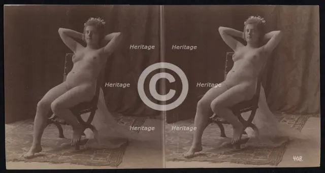 A young woman posing naked but for a long veil, leaning back in a chair, in a photographic..., c1900 Creator: Unknown.