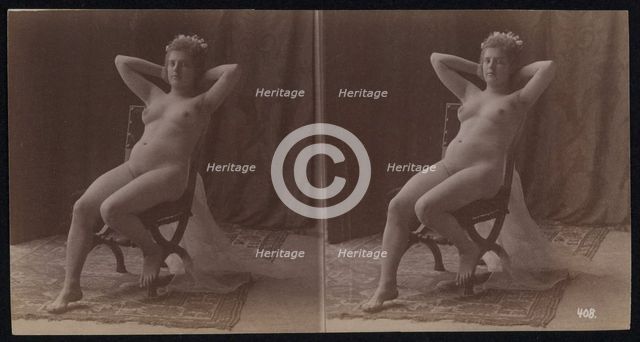A young woman posing naked but for a long veil, leaning back in a chair, in a photographic..., c1900 Creator: Unknown.
