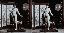A young woman posing naked in a photographic studio, kneeling on a chair..., c1900. Creator: Unknown