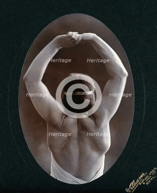 A young woman posing semi-naked, back view, with her arms in the air, in a photographic..., c1903. Creator: Unknown.
