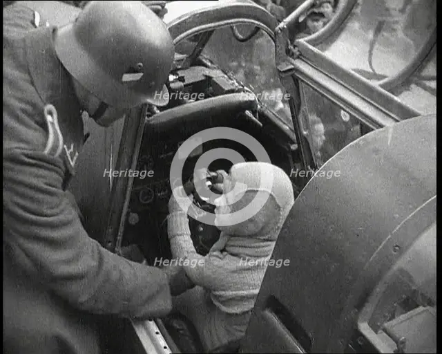 A Young Boy Sitting in the Cockpit of a Fighter Plane, 1930s. Creator: British Pathe Ltd.