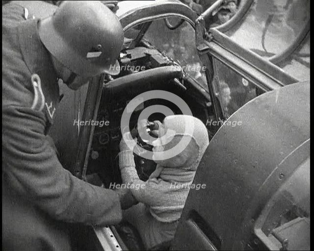 A Young Boy Sitting in the Cockpit of a Fighter Plane, 1930s. Creator: British Pathe Ltd.