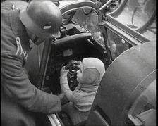 A Young Boy Sitting in the Cockpit of a Fighter Plane, 1930s. Creator: British Pathe Ltd