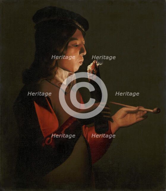 A young boy with a pipe, blowing on a firebrand, 1645-1648.
