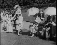 A Young British Girl Approaching the Chair of Queen Mary of Teck With a Purse in Her Hand..., 1939. Creator: British Pathe Ltd