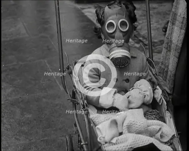 A Young Child in a Pram Wearing a Gas Mask, 1939. Creator: British Pathe Ltd.