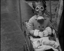 A Young Child in a Pram Wearing a Gas Mask, 1939. Creator: British Pathe Ltd