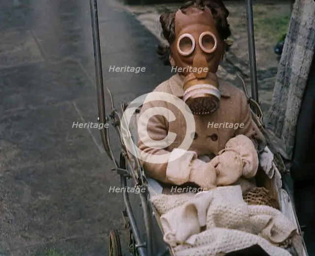 A Young Child in a Pram Wearing a Gas Mask, 1939. Creator: British Pathe Ltd.