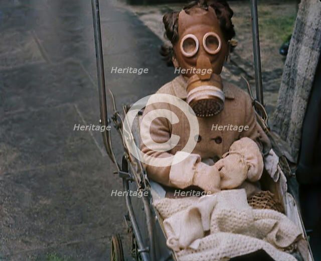 A Young Child in a Pram Wearing a Gas Mask, 1939. Creator: British Pathe Ltd.