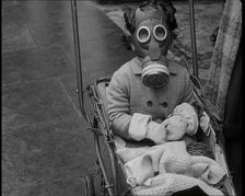 A Young Child in a Pram Wearing a Gas Mask, 1939. Creator: British Pathe Ltd