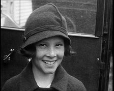 A Young Female American Civilian Being Rescued from Kidnapping Smiling at the Camera, 1930. Creator: British Pathe Ltd