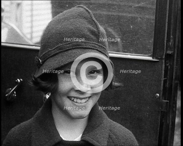 A Young Female American Civilian Being Rescued from Kidnapping Smiling at the Camera, 1930. Creator: British Pathe Ltd.