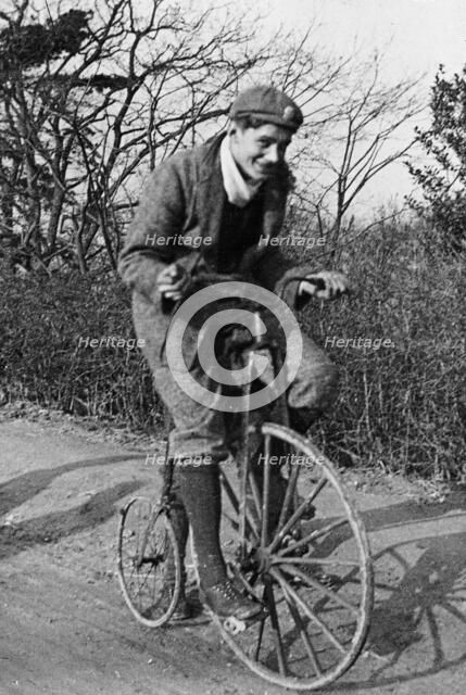 A young Lord Nuffield riding a bicycle down a country lane. Artist: Unknown