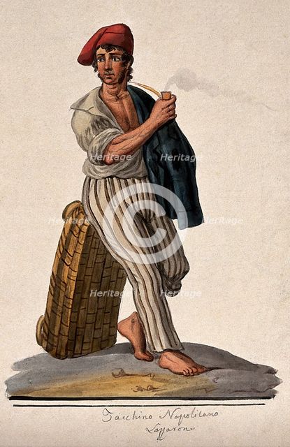 A young man leans against a basket with his jacket slung over his shoulder smoking a pipe. Creator: Unknown.
