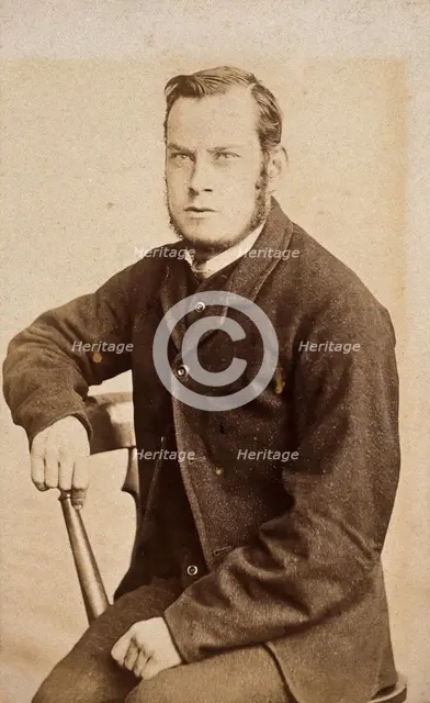 A young man, seated, with an intense expression in his eyes, c1890s. Creator: John Davis.