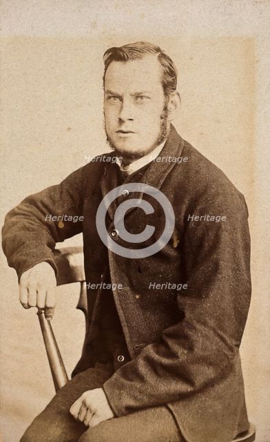 A young man, seated, with an intense expression in his eyes, c1890s. Creator: John Davis.