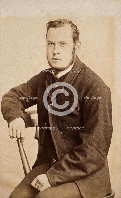 A young man, seated, with an intense expression in his eyes, c1890s. Creator: John Davis.