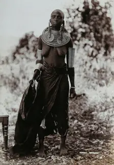 A young Masai woman, full length, wearing much jewellery, 1900. Creator: Unknown