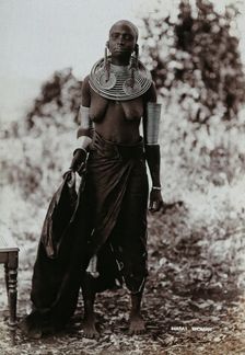 A young Masai woman, full length, wearing much jewellery, 1900. Creator: Unknown