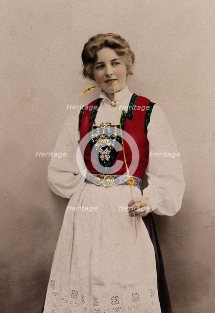 A young Norwegian woman, posing in a photographic studio wearing peasant dress, 1903. Creator: Solveig Lund.