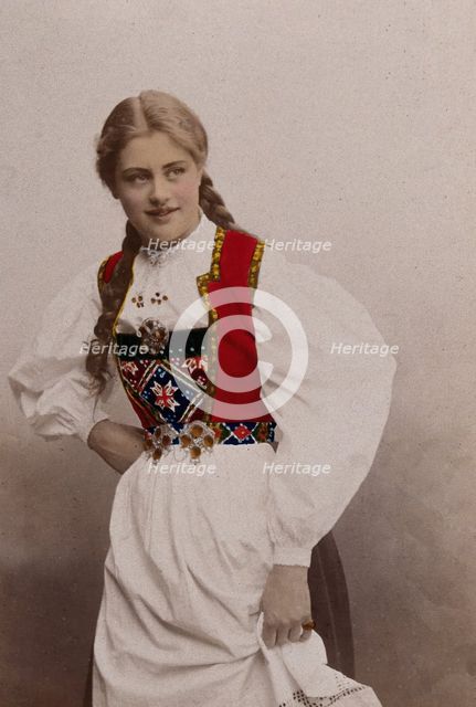 A young Norwegian woman, posing in a photographic studio wearing peasant dress, 1901. Creator: Sostrene Persen.