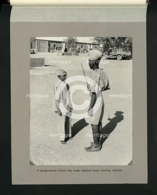 A young recruit enters the Sudan Defence Force Training School, 1964. Creators: Colonial Office, Unknown.