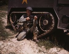 A young soldier of the armored forces holds and sights his Garand rifle like..., Fort Knox, Ky, 1942 Creator: Alfred T Palmer