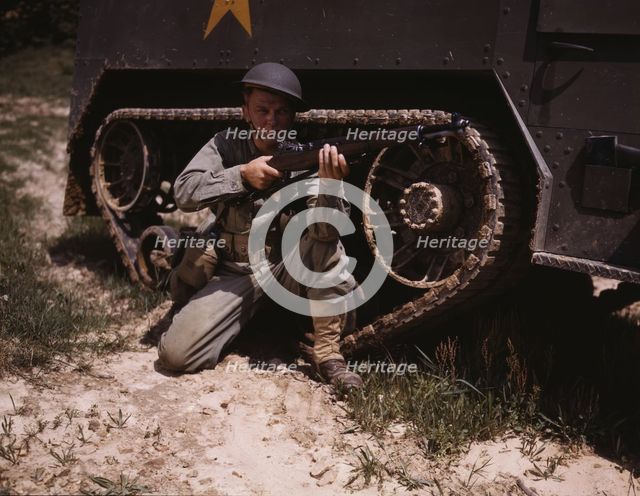 A young soldier of the armored forces holds and sights his Garand rifle like..., Fort Knox, Ky, 1942 Creator: Alfred T Palmer.