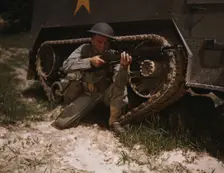 A young soldier of the armored forces holds and sights his Garand rifle..., Fort Knox, Ky, 1942. Creator: Alfred T Palmer