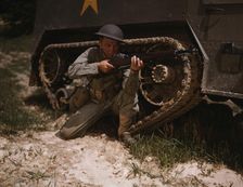 A young soldier of the armored forces holds and sights his Garand rifle..., Fort Knox, Ky, 1942. Creator: Alfred T Palmer