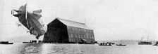 A Zeppelin entering its floating shed, c 1900, (c1920)